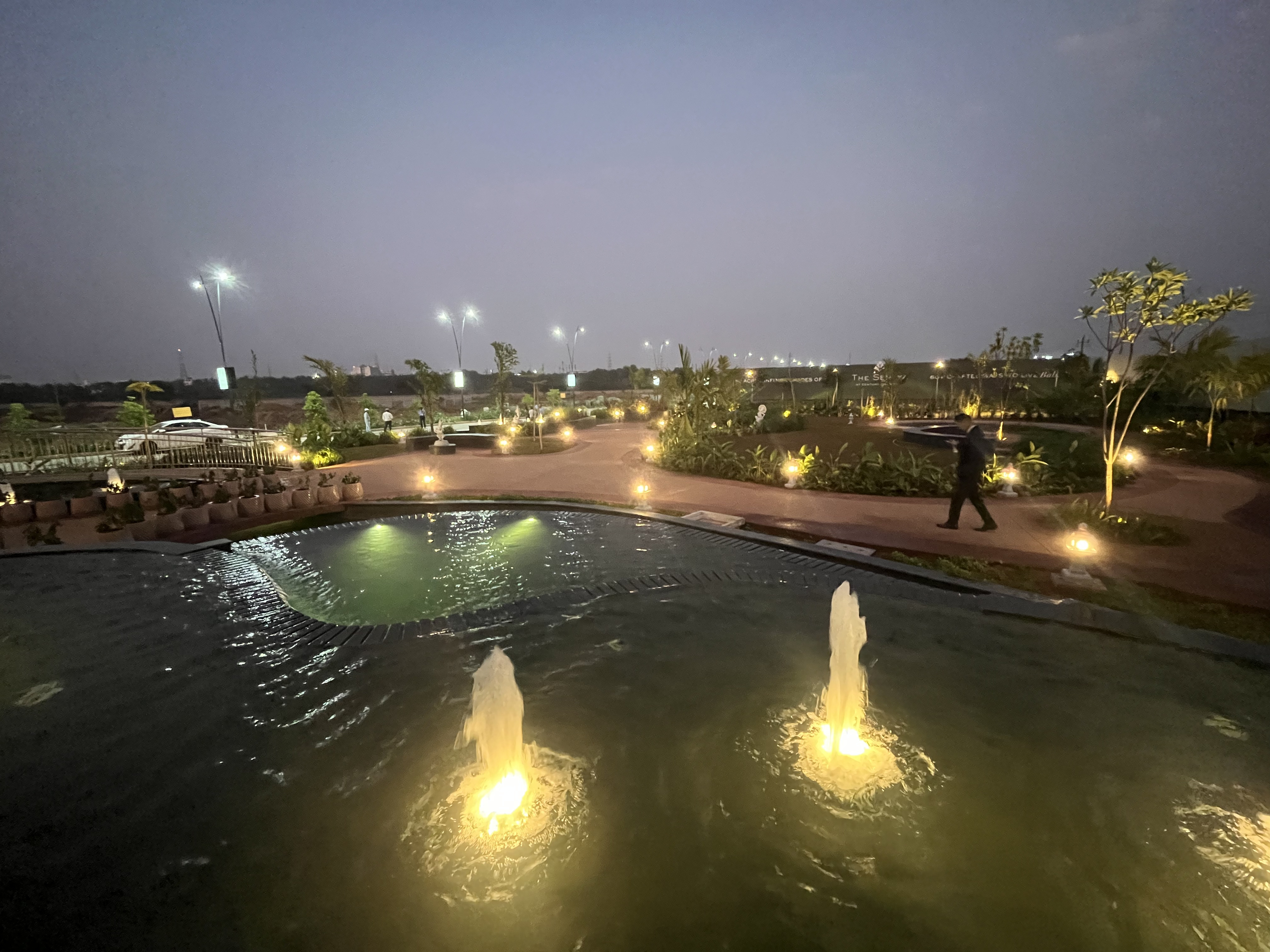 Clubhouse facilities at Century OneWorld gated community illuminated at night